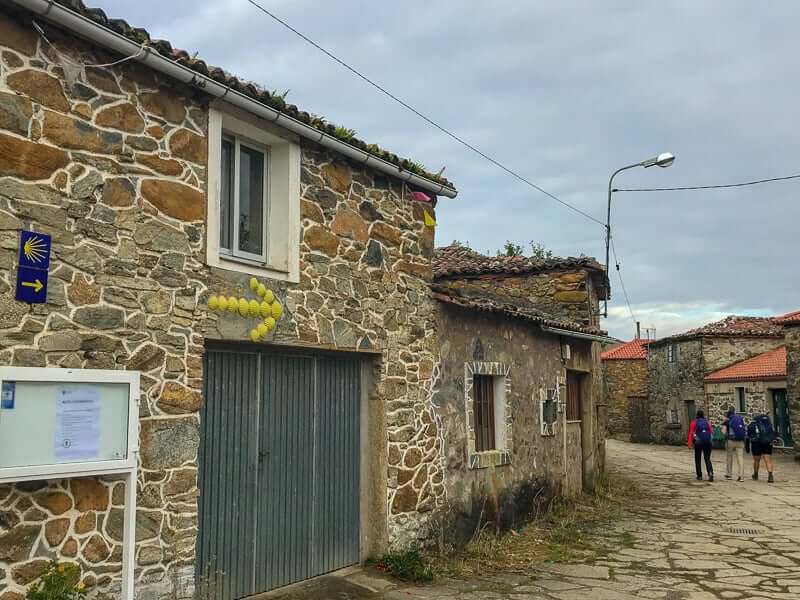 Pilgrims walking through a village on the Camino de Santiago.