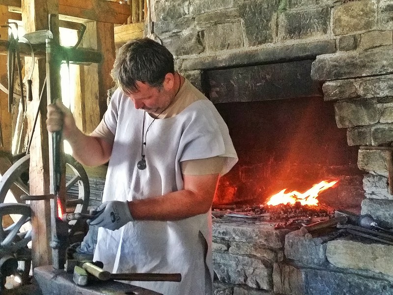 A Burgbau blacksmith using only medieval tools and techniques to build the castle near the medieval village of Freisach in Carinthia.