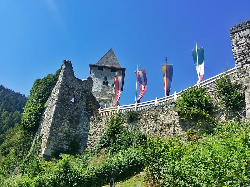 The ruins of Petersberg wall and castle sit on a mountain overlooking the medieval town of Friesach. 