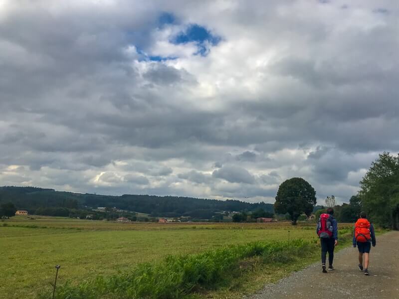 Two pilgrims walking a flat part of the Camino de Santiago (the last 100 km).