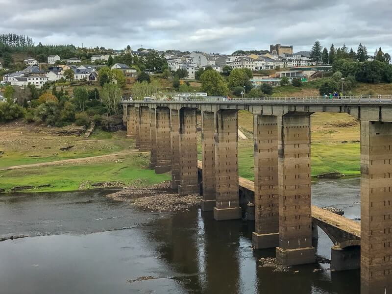 You're in for a dramatic finish of the Camino de Santiago on day 2 of the last 100 km by walking across a long bridge into Portomarin.