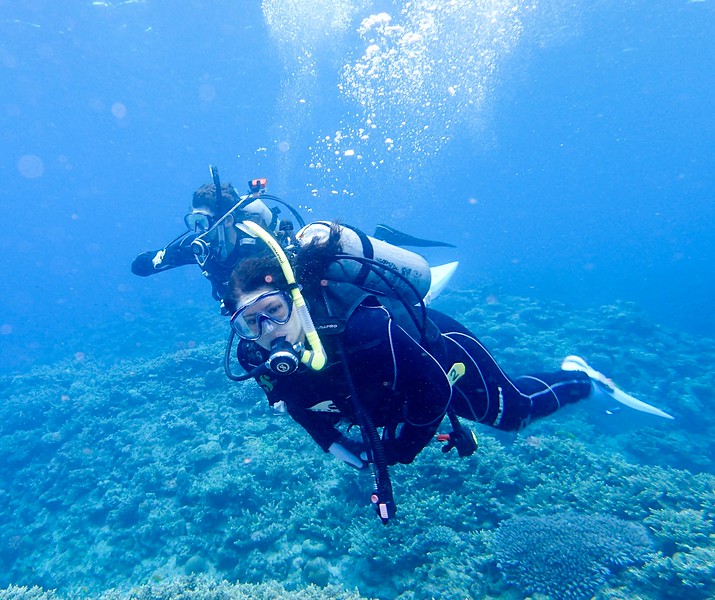 Adventure travel blogger Laurel Robbins diving Keramashoto National Park in Okinawa.