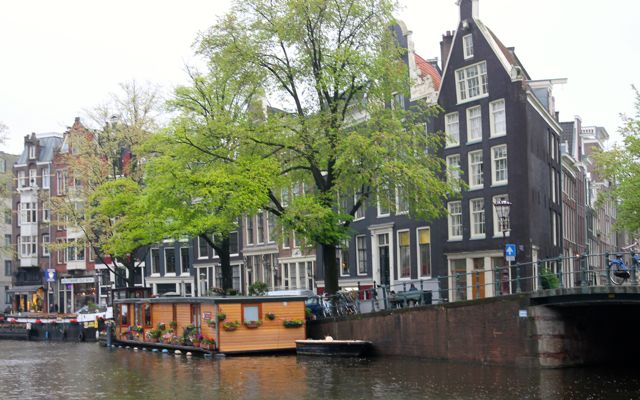 Town hall and Chinese center seen from a canal in Amsterdam.