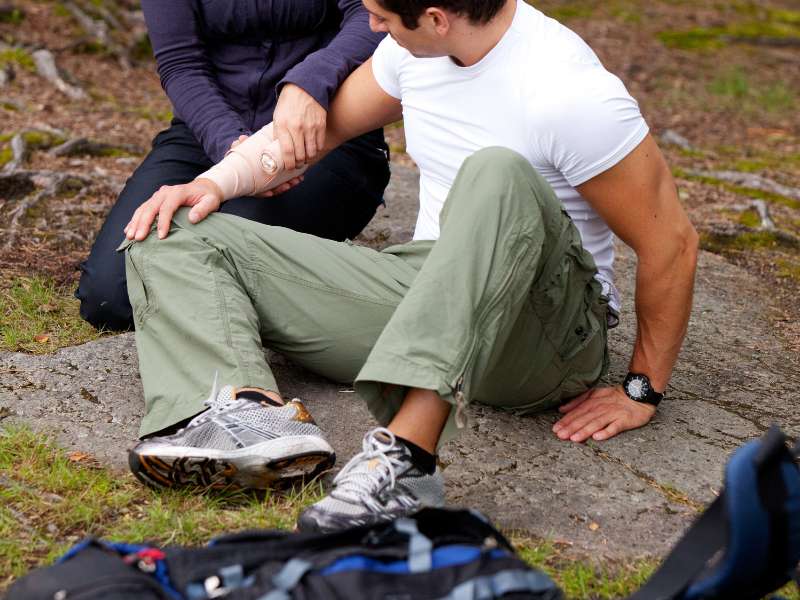 hiker bandaging an injured arm