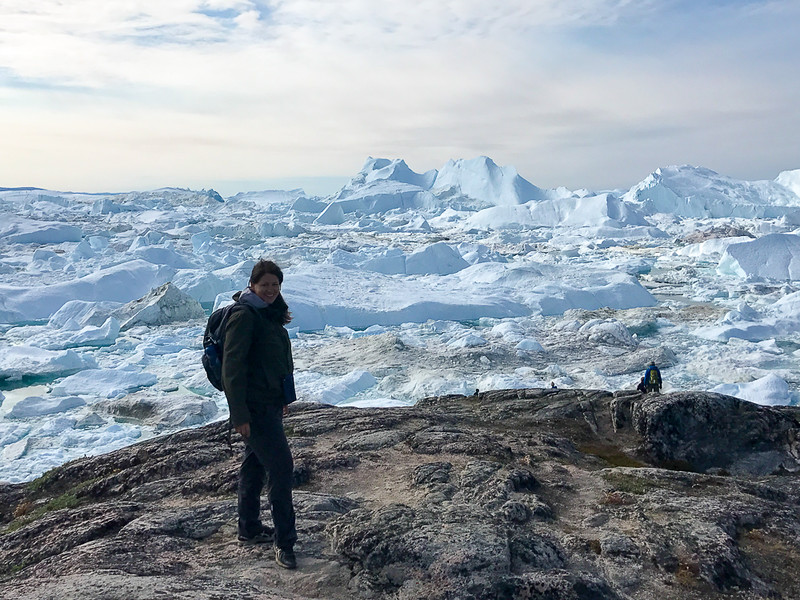 Adventure travel blogger Laurel Robbins in front of the Ilulissat Icefjord in Greeland.