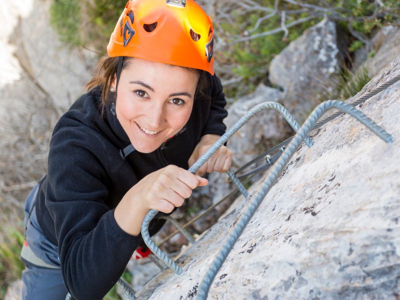 lady on a via ferrata ladder