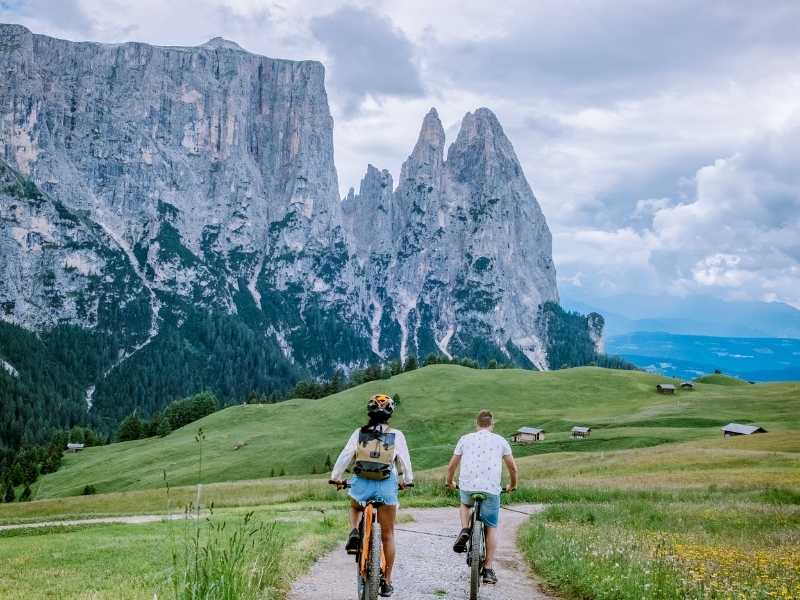 cyclists in Alpe di Siusi with mountains in the background