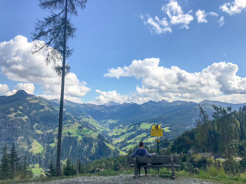 Hiker relaxing and enjoying the views over Grossarl, Austria