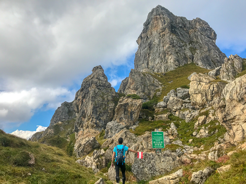 Hiker approaching the mountain peak the Shuhflicker in Grossarl, Austria.