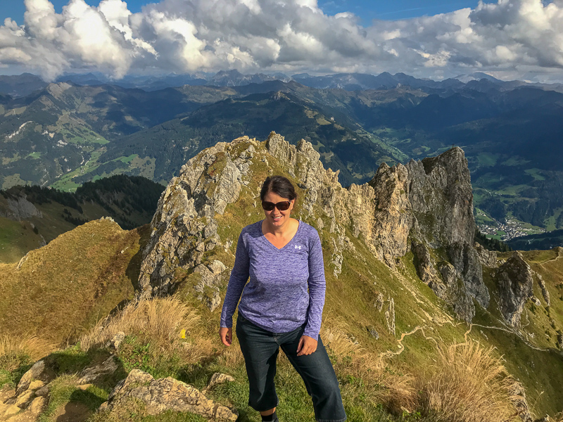 Adventure traveller Laurel Robbins at the top of mountain peak, the Shuhflicker in Grossarl.