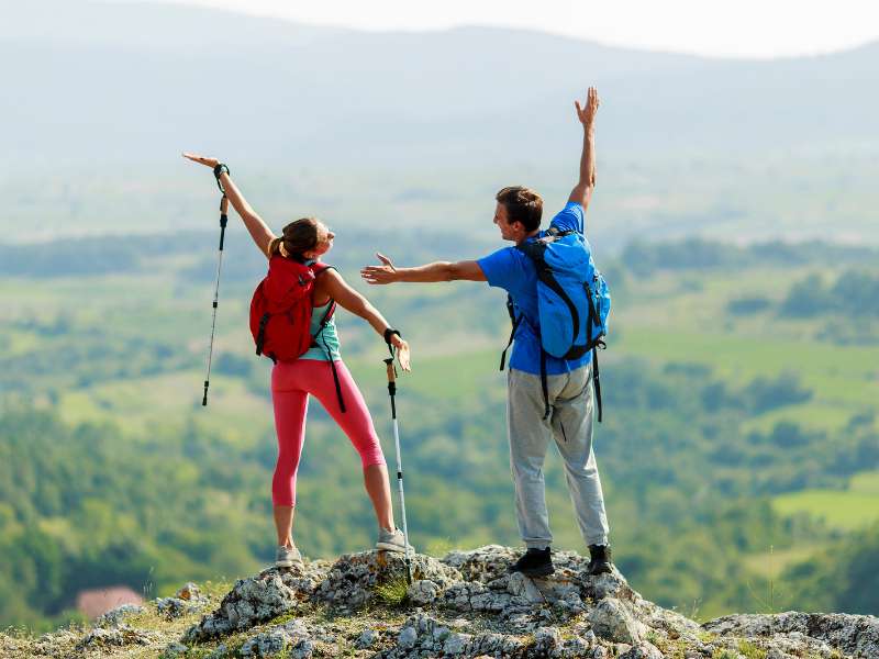 hiking couple at the top of the mountain