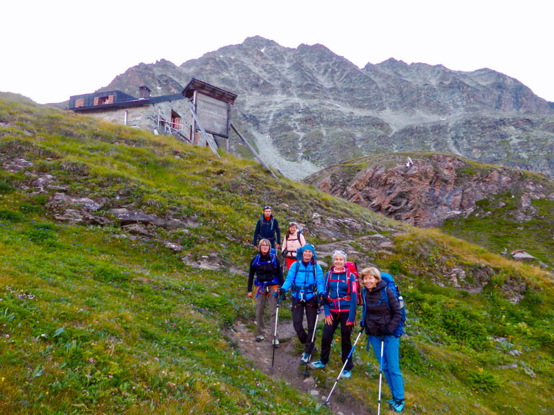 Hikers arriving to a Mountain Refuge in the Haute Route From Chamonix to Zermatt