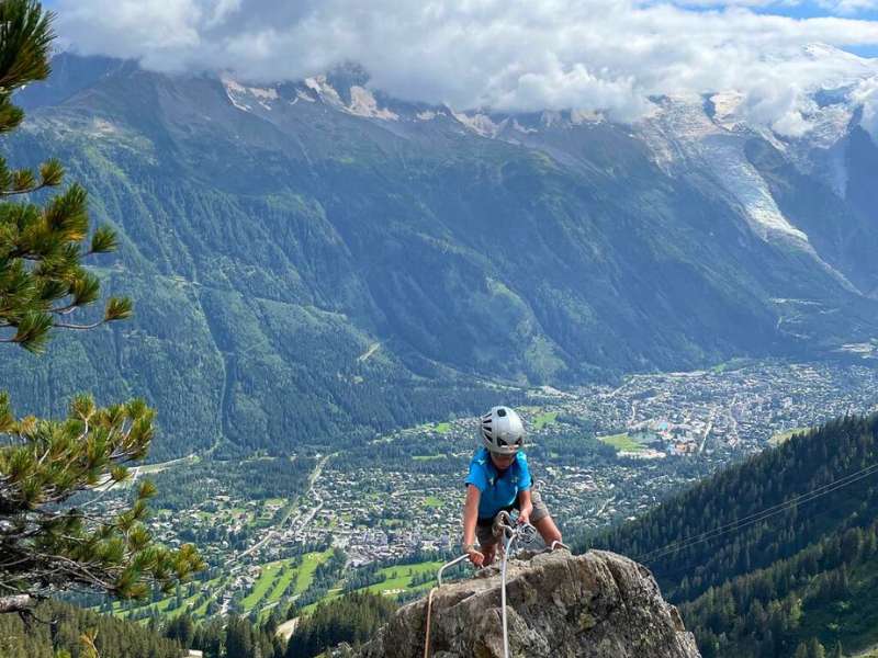 hiker rock climbing the via ferrata