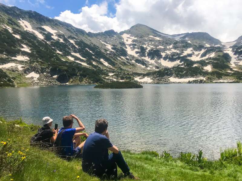 hikers enjoying the view near a lake