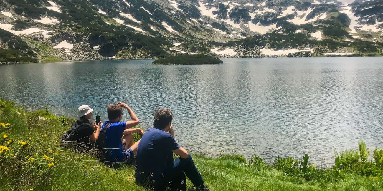 a group of hikers resting near the lake