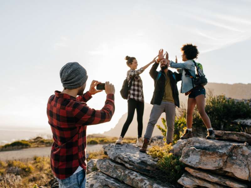 group of friends taking a picture while hiking