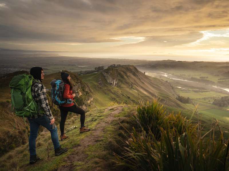 hiking couple enjoying the view from the mountain