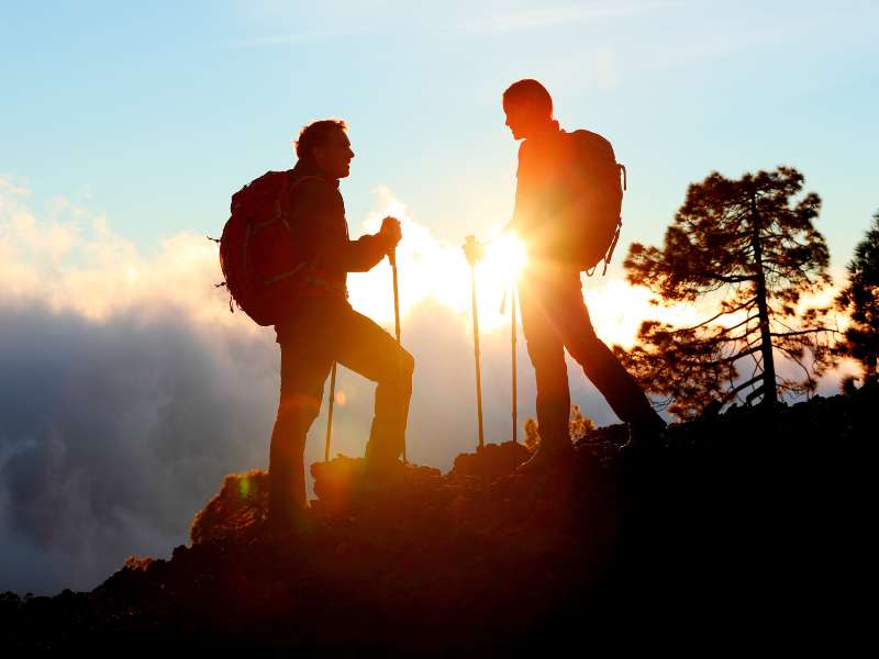 hiking couple enjoying the sunset view