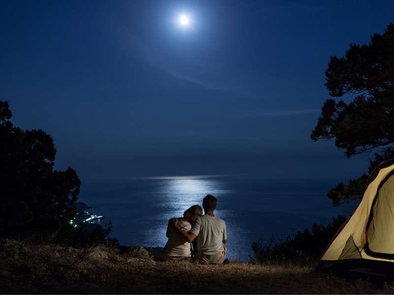 hiking couple enjoying the moonlight