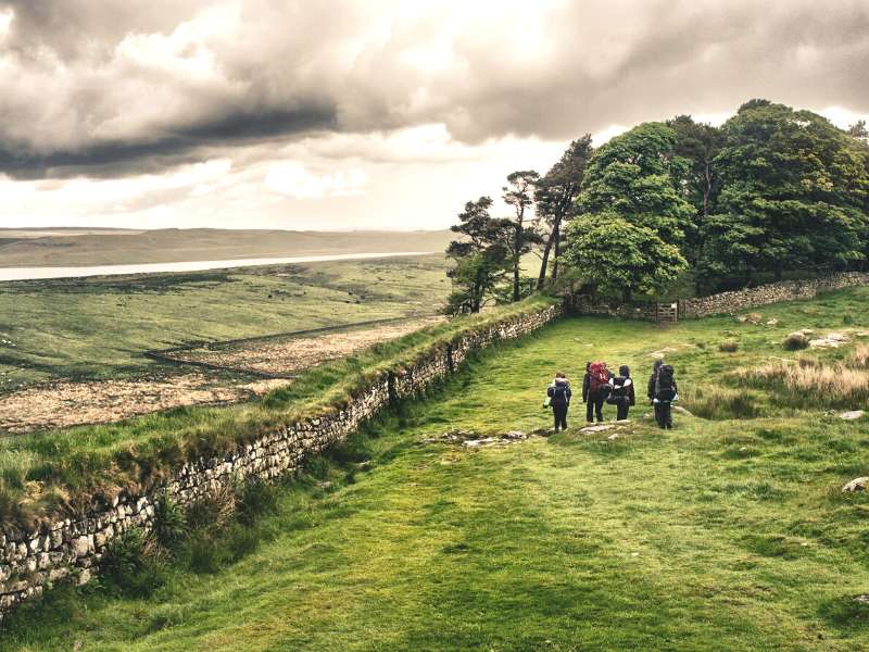 group of friends hiking in hadrian's wall