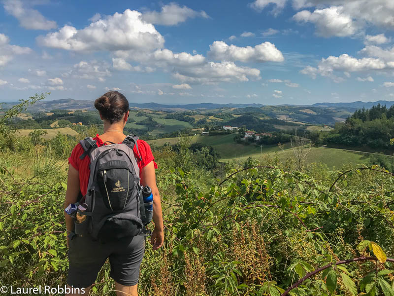 hiker enjoying views of the Bologna Hills from the Path of Gods Italy