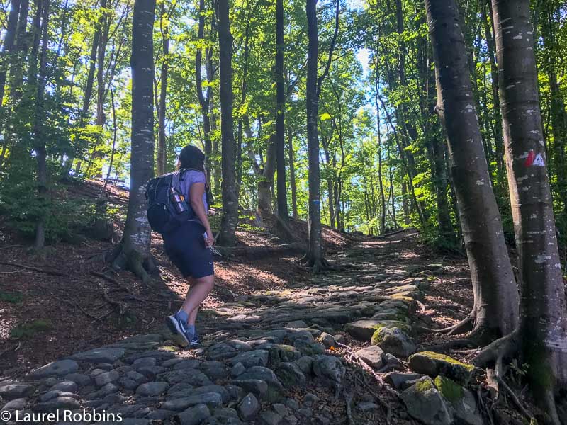 Hiker walking on the Roman Road of the Path of Gods Italy