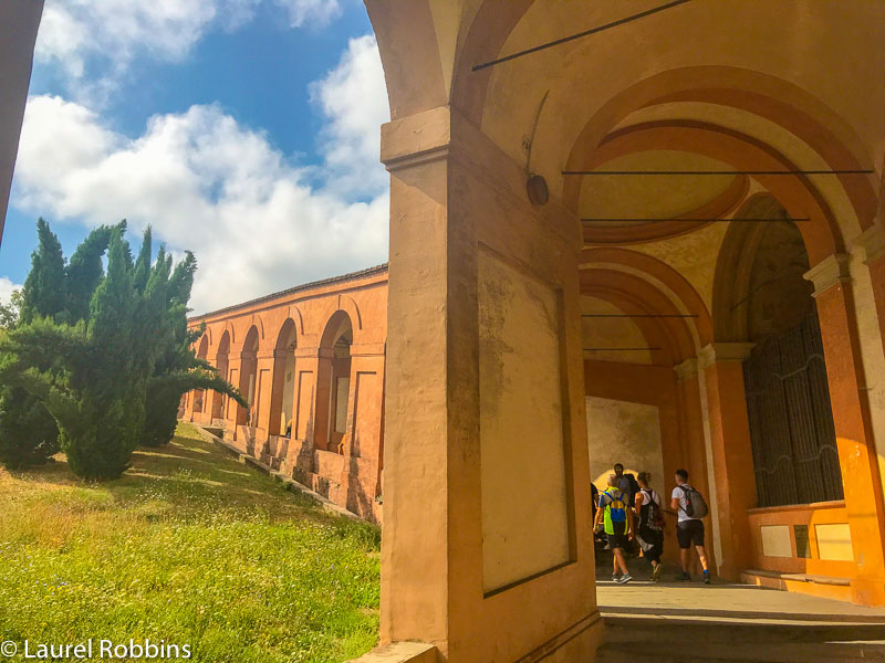 your hike starts by walking under the porticos in Bologna