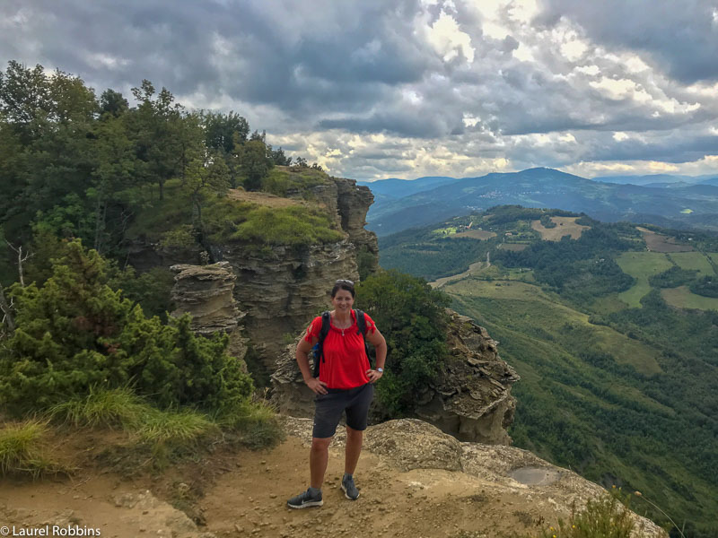 Hiker at Mont Adonis overlooking the Bologna Hills on the Path of Gods Hiking Trail in Italy