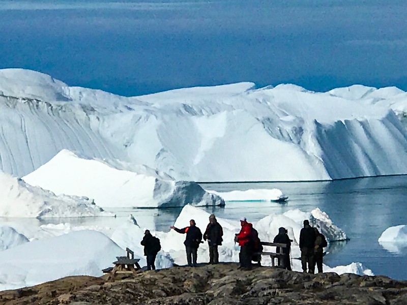 Travellers enjoying the Ilulissat Icefjord, a UNESCO site and one of the highlights of our Arctic adventure.