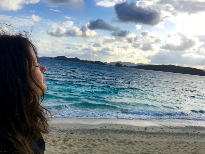 Adventure travel blogger Laurel Robbins enjoying the ocean breeze on Aka Island in Okinawa, Japan. 