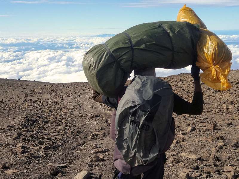 hiker at the top of Kilimanjaro mountain