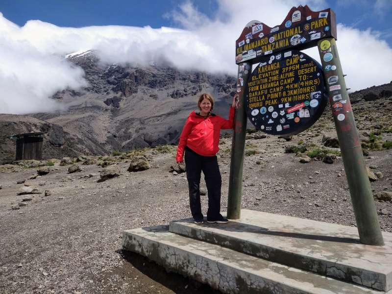 Laurel near a kilimanjaro tour mountain signage