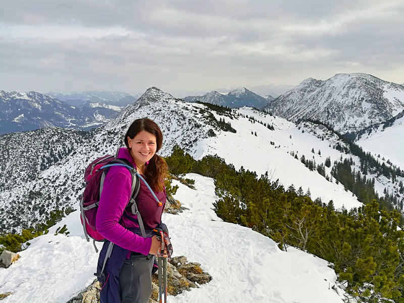 hiker wearing winter hiking clothing in the Alps