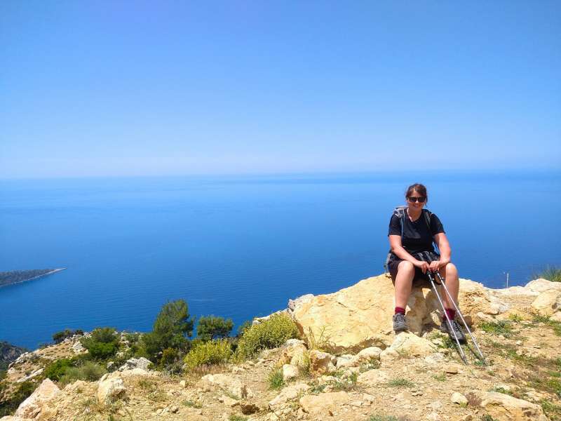 laurel sitting on the rock at the top of the mountain during the lycian way tour