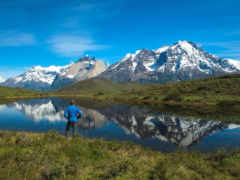 man enjoying the view of the mountains