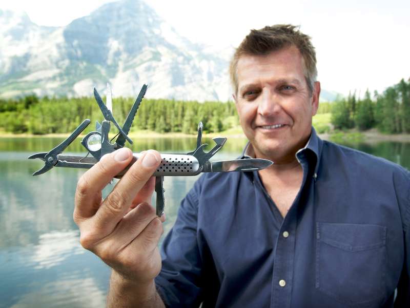 man holding a multitool for hiking or camping