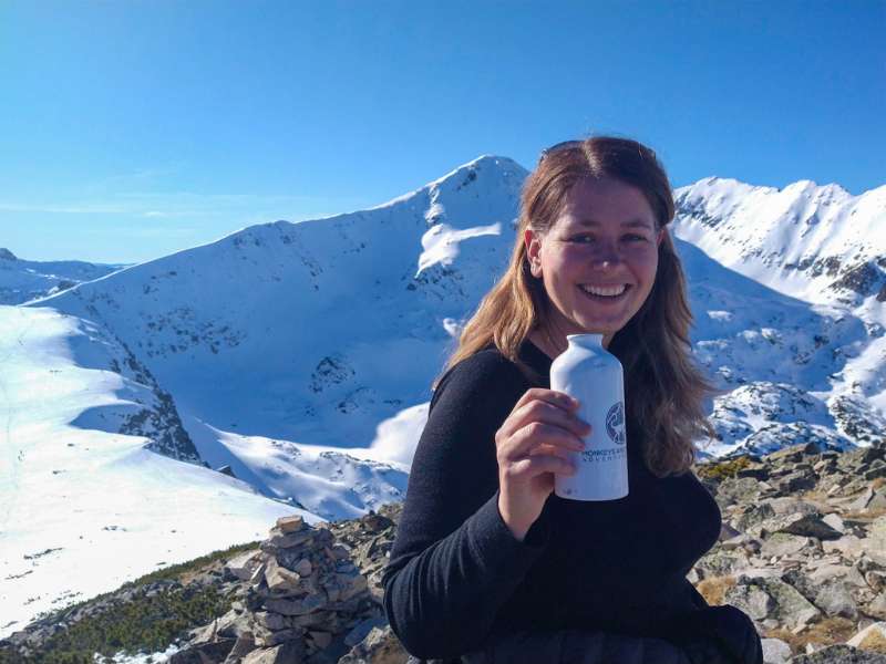 Laurel in Merino wool base layer and water bottle while on winter hike