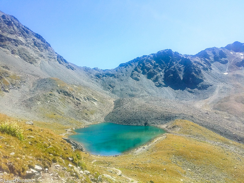 Trail from Muottas Muragl to Lej Muragl, a scenic hike in the Engadin mountains near St. Moritz, Switzerland.