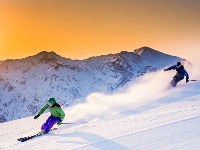 couple skiing in courmayeur ski resort