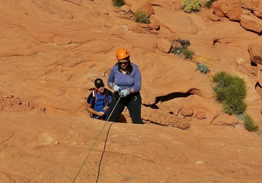 adventure travel blogger Laurel Robbins rappelling in Valley of Fire State Park in Nevada.