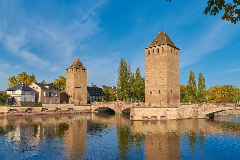 Stone bridges create pathways over the canals