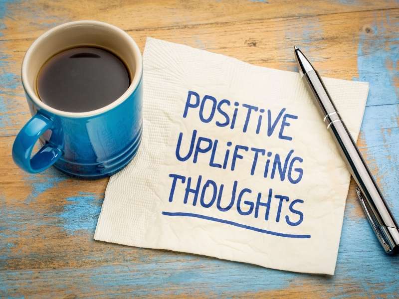 napkin with writing "positive uplifting thoughts"