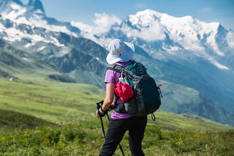 Hiker relaxing and enjoying the views of Mount Blanc. Trekking tips can help make your hike better.