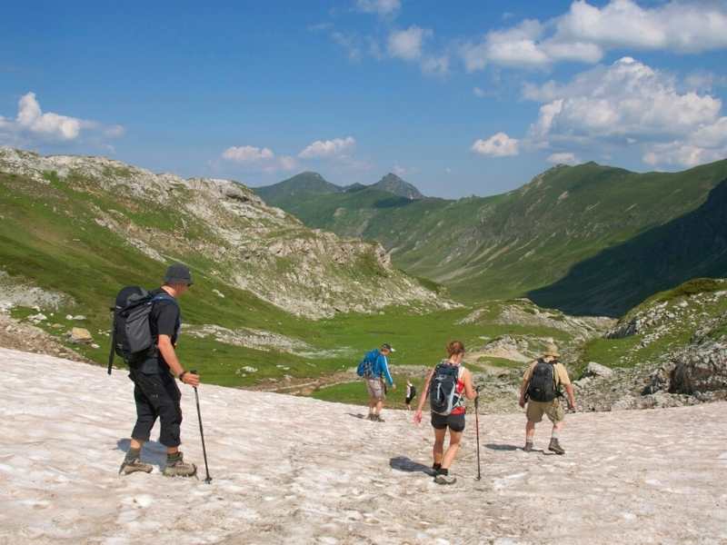 Hikers descending from a summit in Albania on the Via Dinarica Hiking Tour