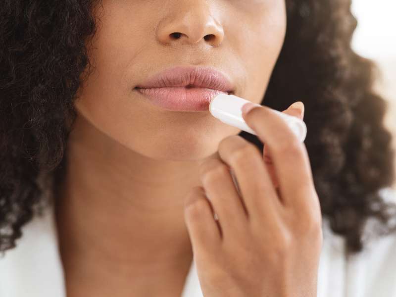 woman using lip balm before before hiking