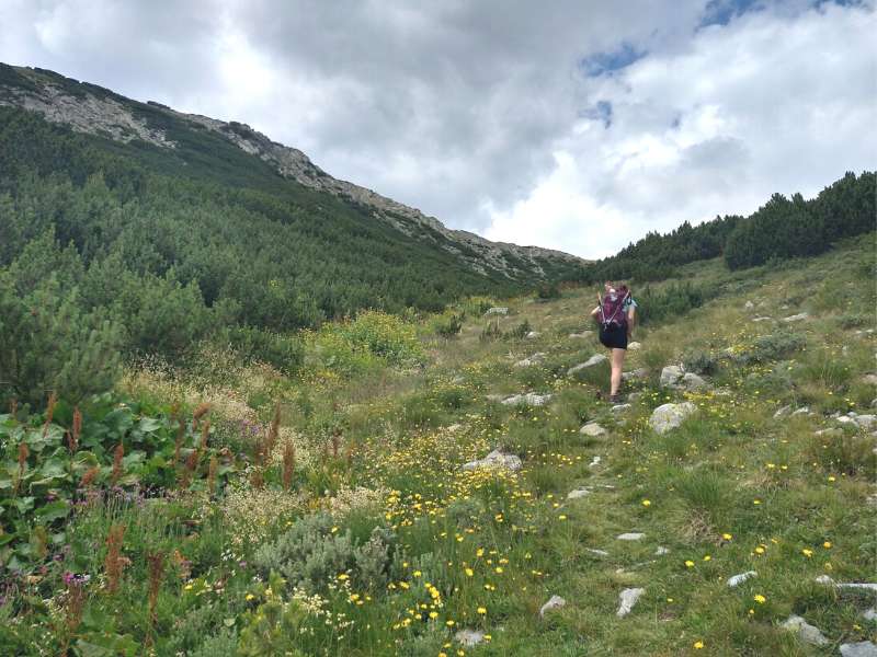 woman steep climbing a mountain