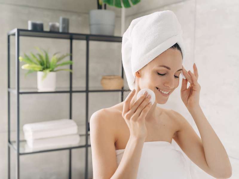 woman cleansing her face before hiking