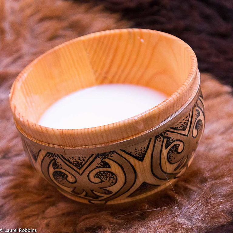 A bowl of yaks milk served in a yurt.